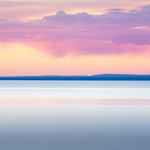 Long exposure of Lake Superior at sunrise with purple rain clouds and pinks and blues