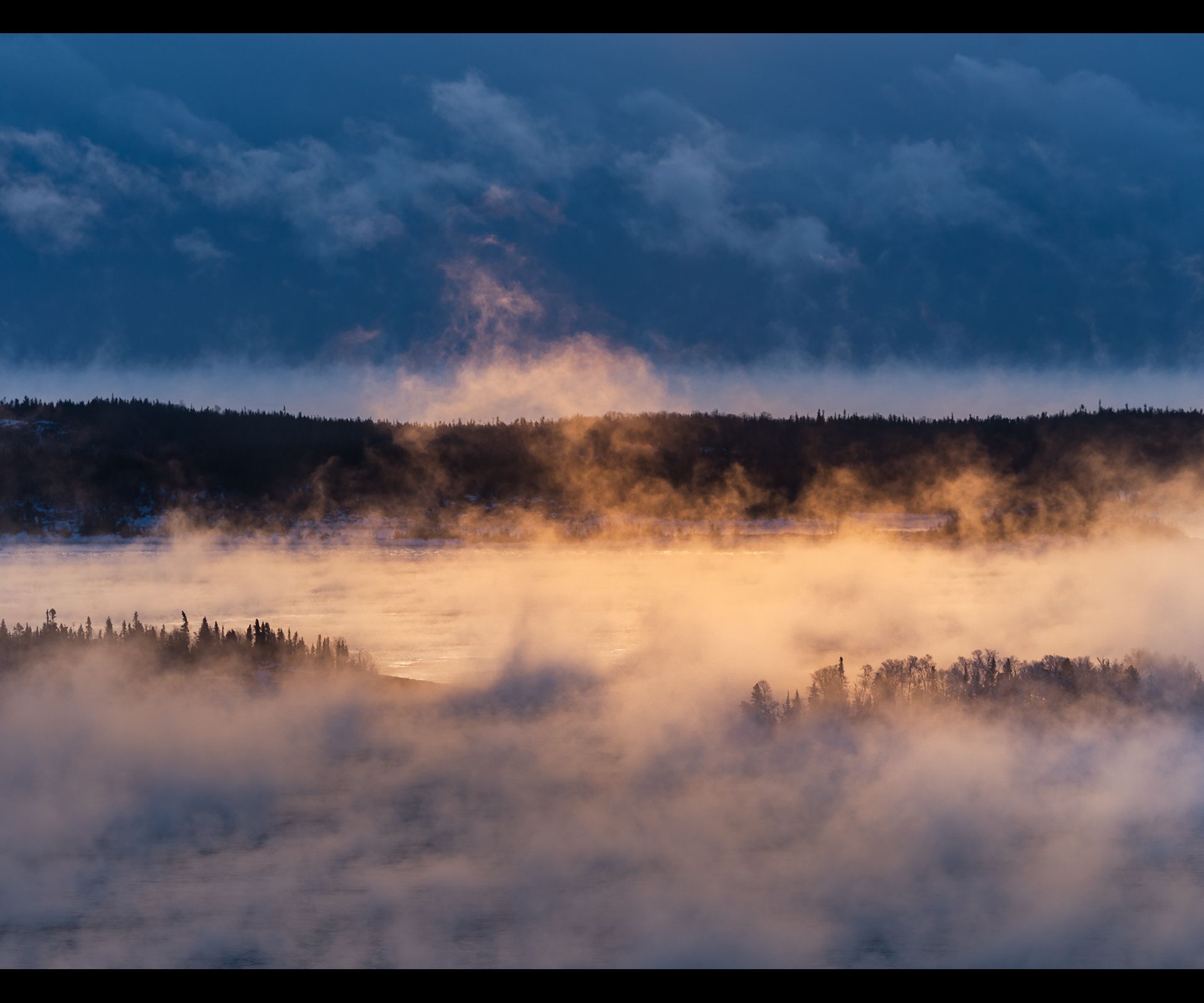 Islands of Lake Superior admist sea smoke at sunrise