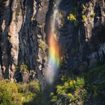 roadside waterfall with a rainbow